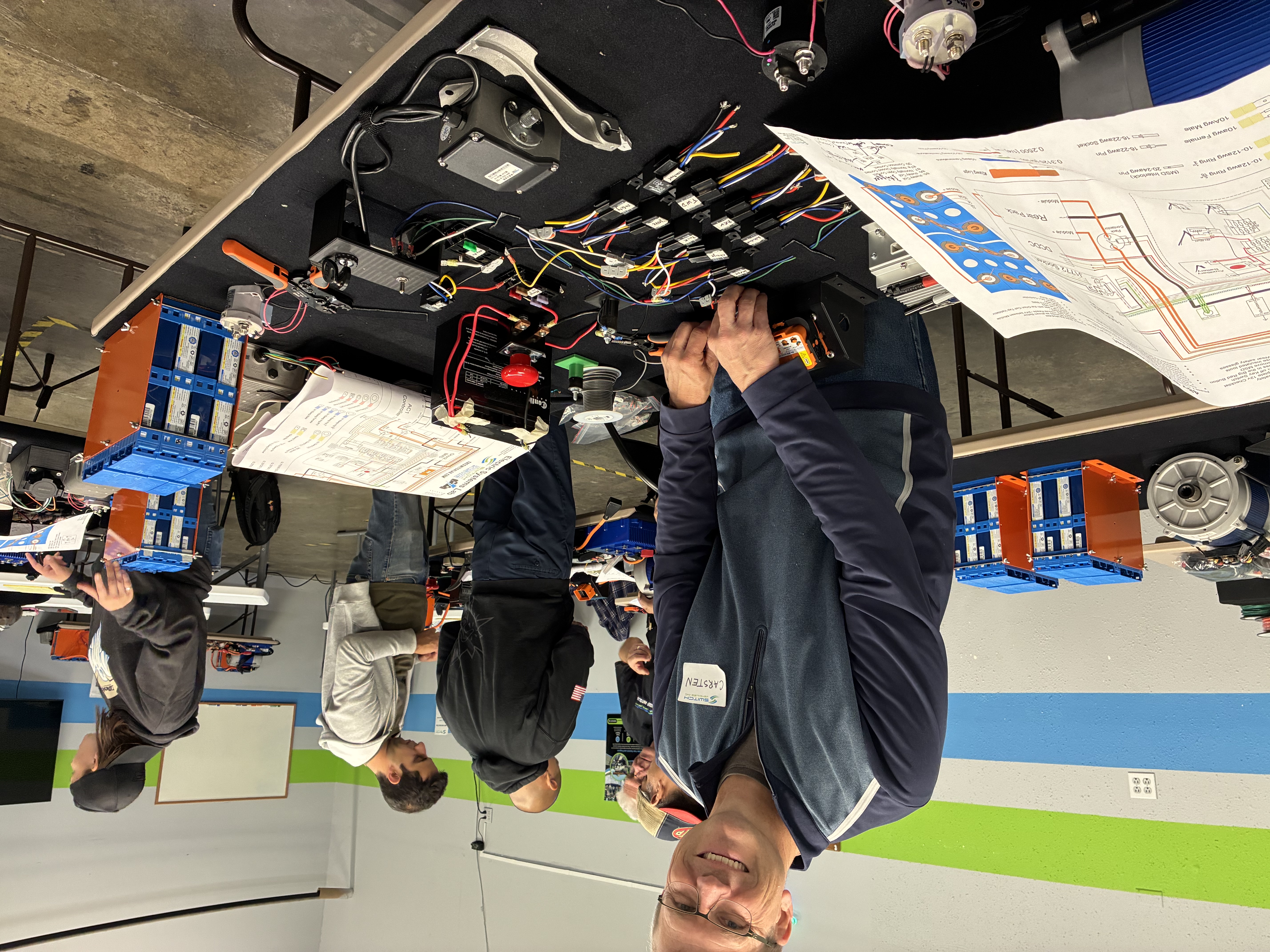 Carsten Puls working with EV conversion components at the MakeMineElectric workshop
